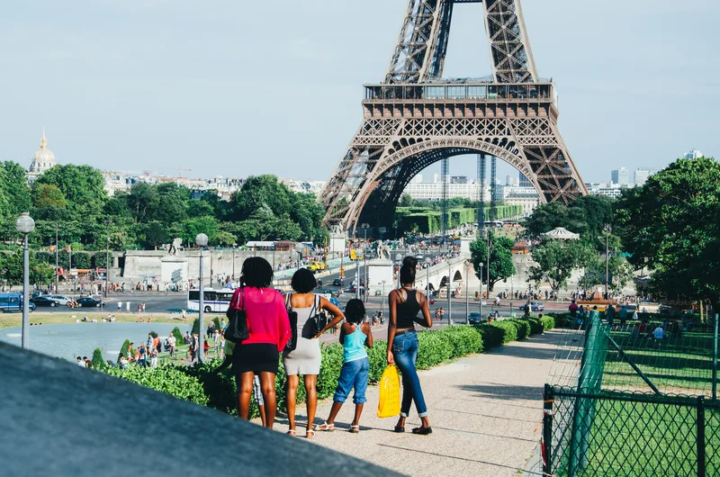 Family looking toward the Eiffel Tower across a park