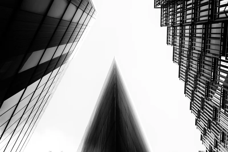 Two glass towers converging, seen from below, black and white