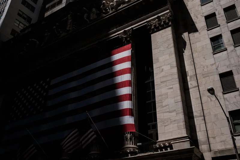 Large American flag hung across a building façade