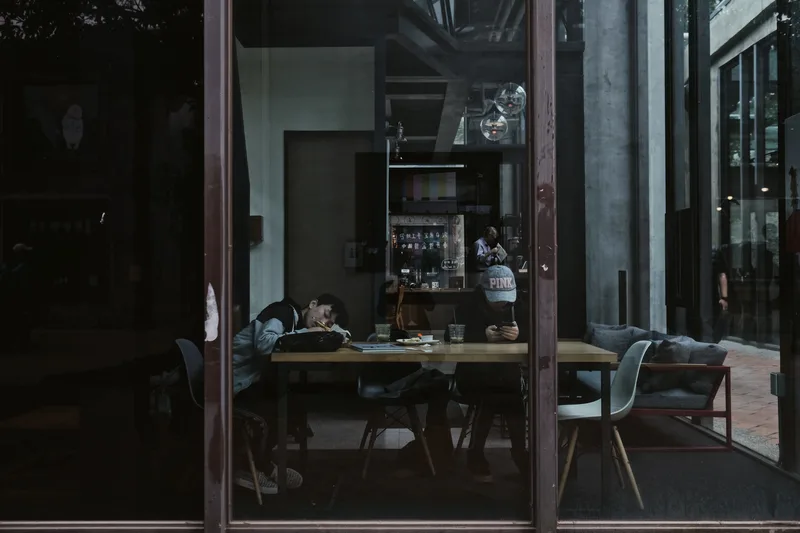 Café interior seen through glass at dusk