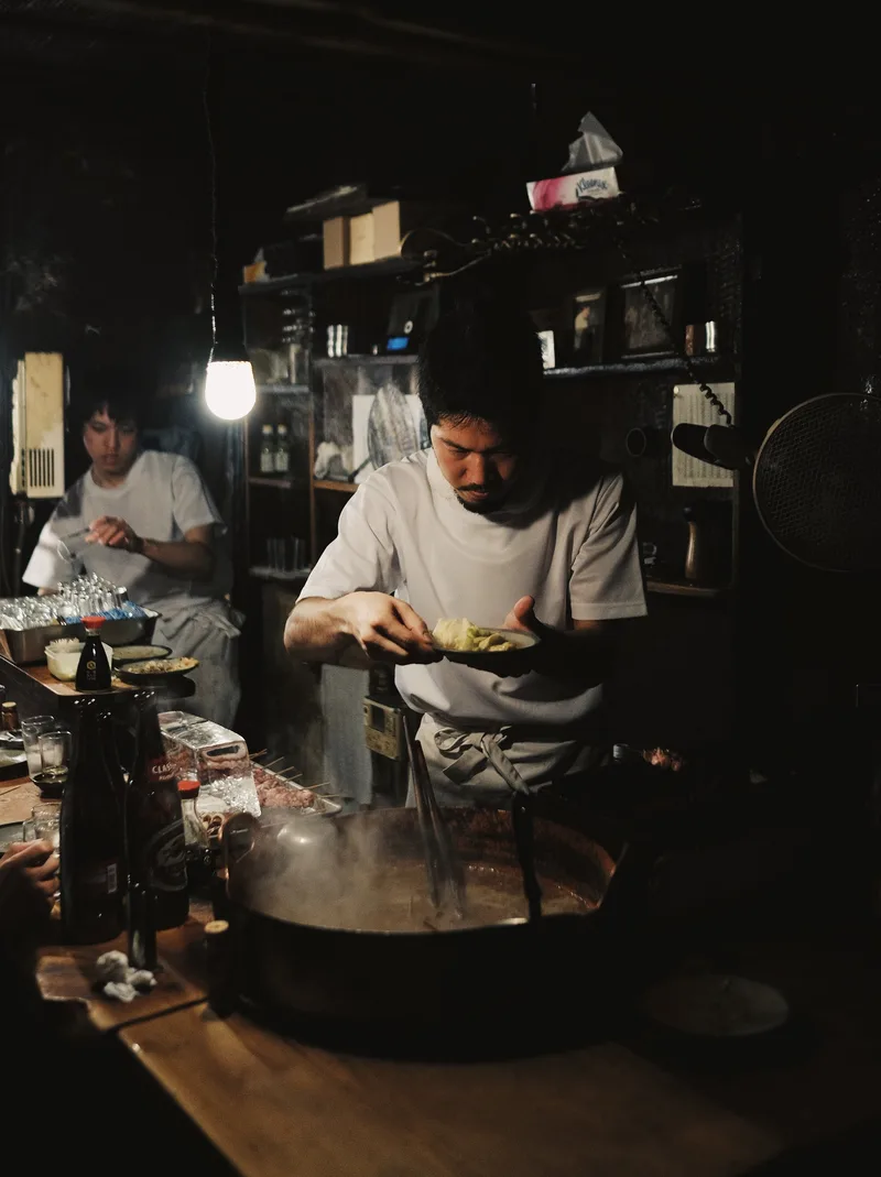 Cook at work in a small dark kitchen