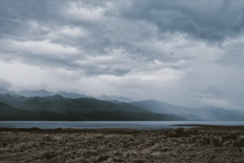 Broad valley and lake under low cloud