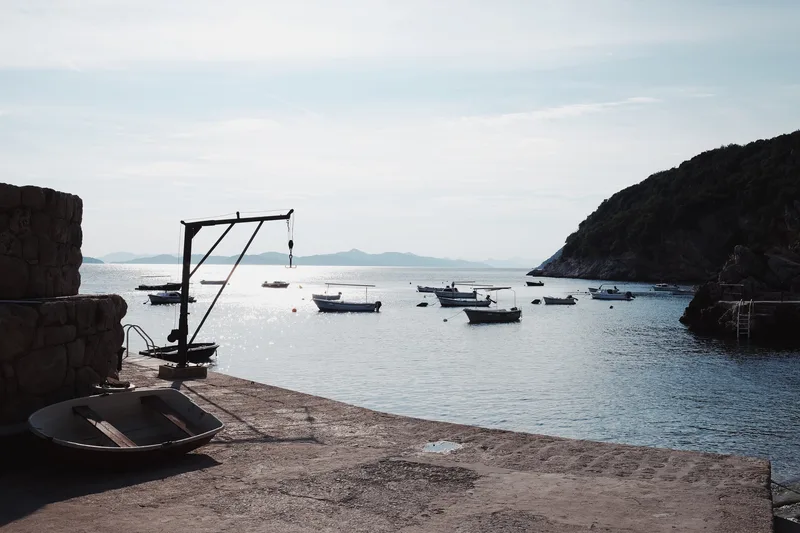 Fishing boats moored in a bay beside a stone quay