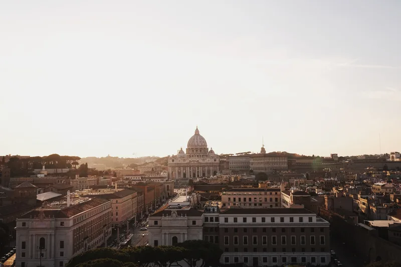 Rooftops toward a great dome in pale hazy light