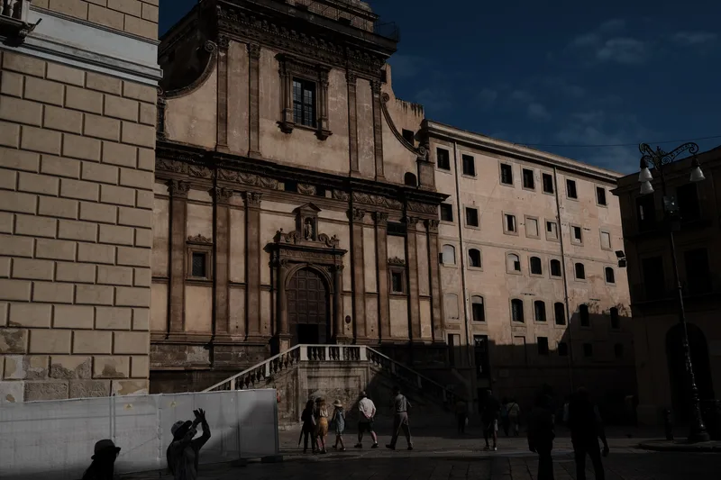 Baroque church façade on a square at dusk