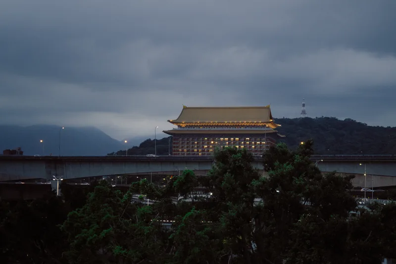 Tiered temple roof on a hillside above the sea in mist