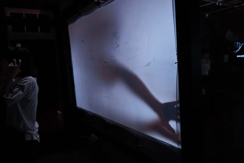Dark room with a projected image on a large screen